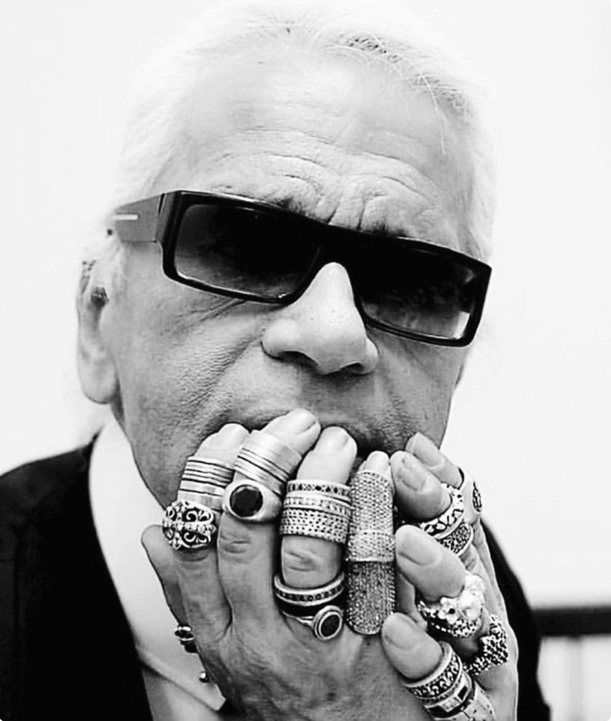 Iconic black and white photography of designer Karl Lagerfeld showcasing his legendary personal uniform and elaborate jewelry