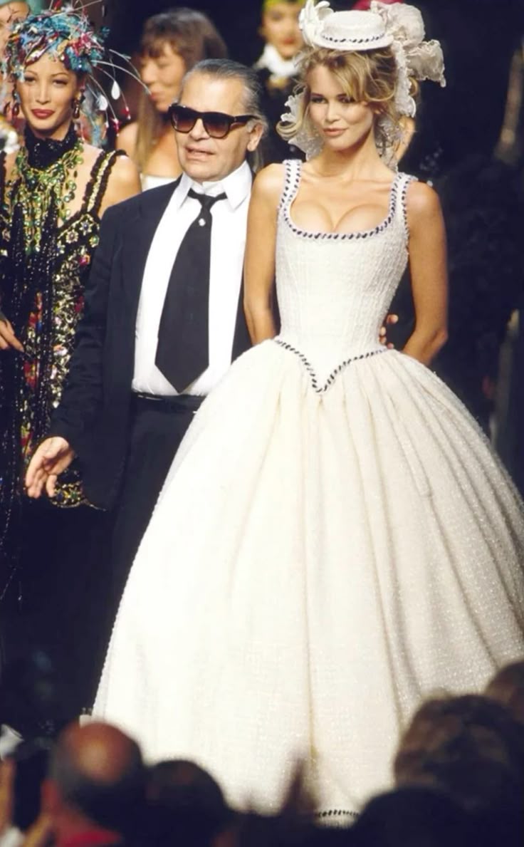 Karl Lagerfeld and supermodel Claudia Schiffer walking the runway at the iconic Chanel Fall/Winter 1993 Haute Couture fashion show