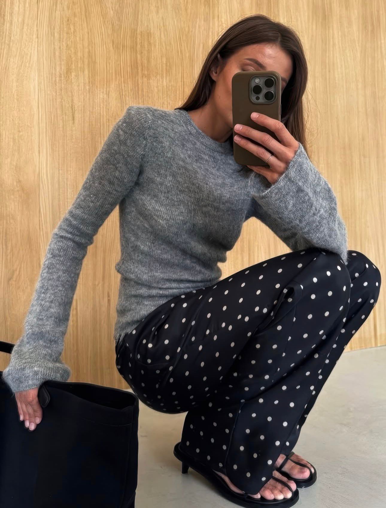 Close-up of a modern spring street style look featuring the micro-dot print trend effortlessly styled with neutral tones