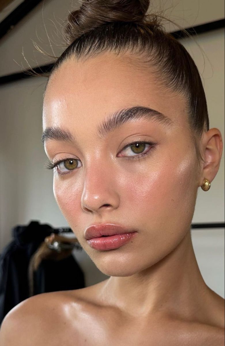 Hyper-glow realism makeup with a luminous skin finish and natural texture for 2026 beauty trends